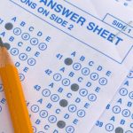 Pencil laying on a filled in Scantron test form